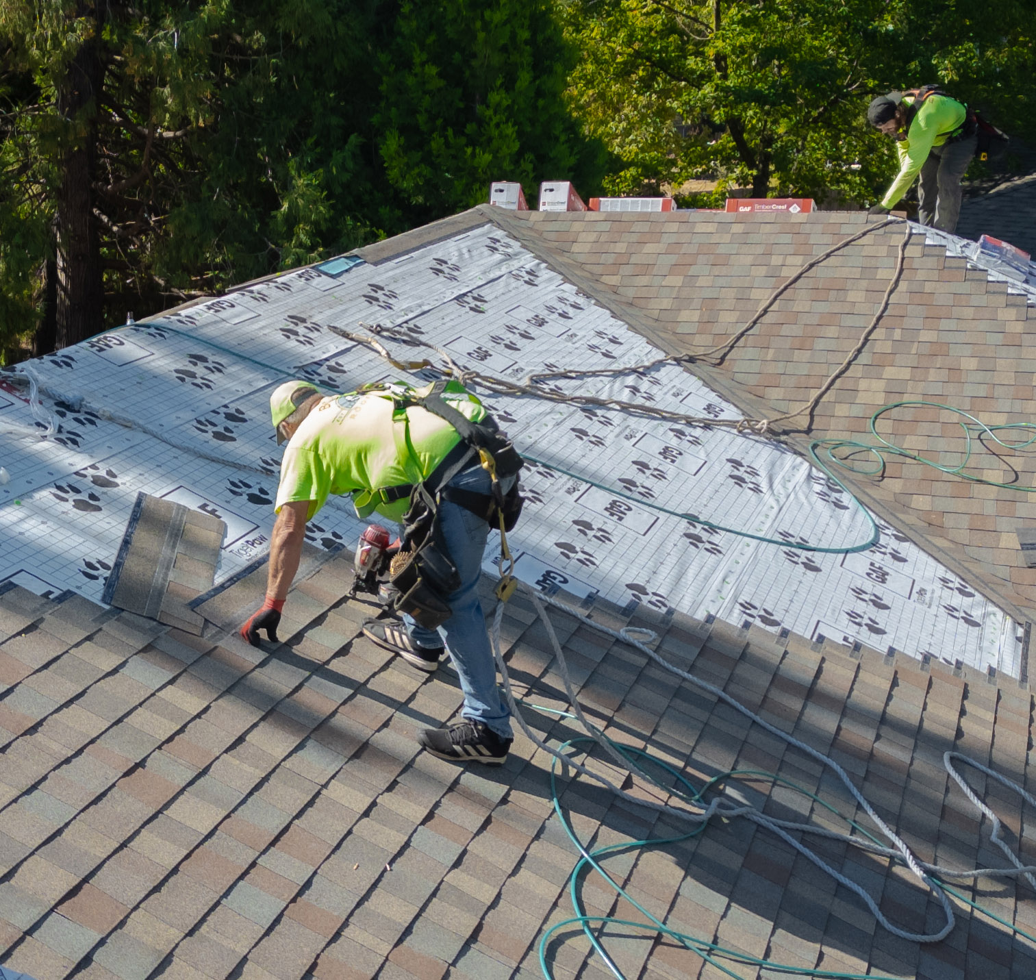 Butte Roofing crew installing shingles on a home