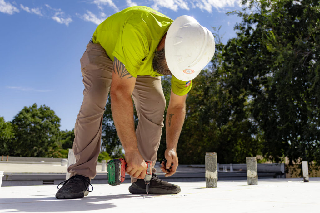 Crew-16 (3) Butte roofing crew member working on commercial roof in northern california