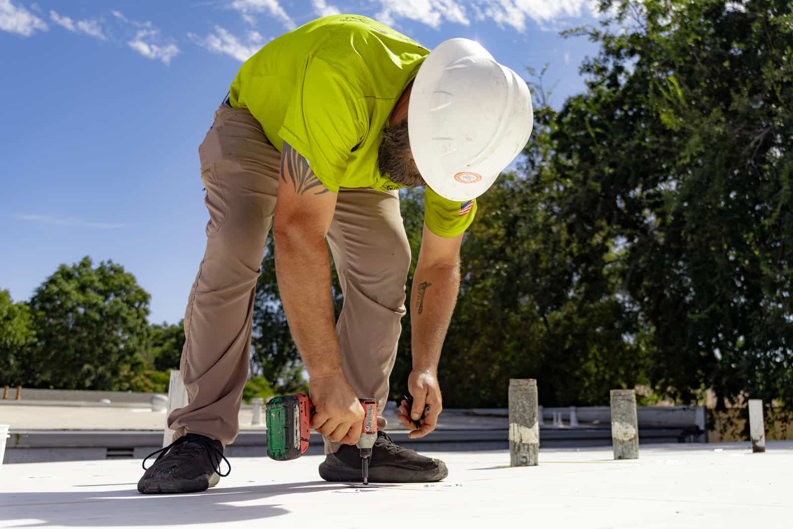 Butte roofing crew member working on commercial roof in northern california