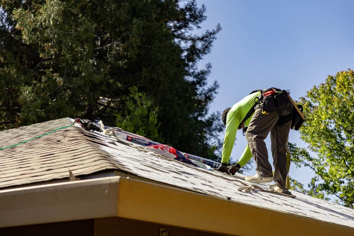 Butte roofing company worker replacing roof on residential home in northern california