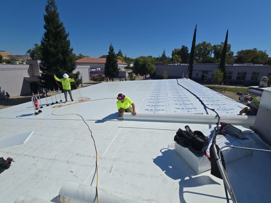 School-commercial-roofing Butte roofing company workers working on commerical flat roof in northern CA